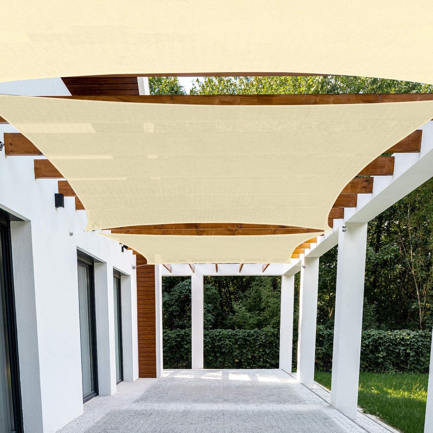 Layered blue, cream and ochre triangular SunSails providing shade